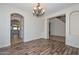 Dining room featuring hardwood floors, custom lighting, and access to the kitchen at 248 S 167Th Dr, Goodyear, AZ 85338