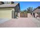 A long driveway with a secured gate leading to the garage, enhances privacy and curb appeal at 248 S 167Th Dr, Goodyear, AZ 85338