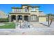 Two-story home with stone accents, tile roof, and arched entry offers an inviting facade at 248 S 167Th Dr, Goodyear, AZ 85338