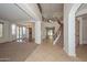 Grand foyer boasts a curved staircase, wrought iron railings, and natural light at 248 S 167Th Dr, Goodyear, AZ 85338
