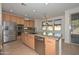 Gourmet kitchen boasts stainless appliances, granite counters, and an island with a sink at 248 S 167Th Dr, Goodyear, AZ 85338