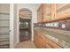 Additional kitchen counter space features upper glass cabinets and granite countertops at 248 S 167Th Dr, Goodyear, AZ 85338