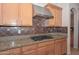 Well-equipped kitchen features granite countertops, stainless hood, and gas range at 248 S 167Th Dr, Goodyear, AZ 85338