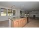 Open kitchen featuring a granite island with sink, stainless steel appliances, and tile flooring at 248 S 167Th Dr, Goodyear, AZ 85338