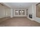 Spacious living room featuring neutral carpet and a fireplace for cozy ambiance at 248 S 167Th Dr, Goodyear, AZ 85338
