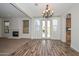 Open living room with fireplace, hardwood flooring and french doors to the backyard at 248 S 167Th Dr, Goodyear, AZ 85338
