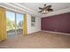 Spacious main bedroom boasts a balcony, neutral carpeting, recessed lights, and modern ceiling fan at 248 S 167Th Dr, Goodyear, AZ 85338