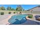 Backyard pool with attractive stone waterfall feature is surrounded by desert landscaping at 248 S 167Th Dr, Goodyear, AZ 85338