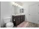 Spacious bathroom with double sinks, fluffy rug, modern fixtures, and separate toilet room at 2511 W Queen Creek Rd # 262, Chandler, AZ 85248