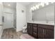 Modern bathroom featuring a double vanity, wood look floors, and a glass-enclosed shower at 2511 W Queen Creek Rd # 262, Chandler, AZ 85248