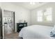Cozy bedroom with plantation shutters, a ceiling fan, and view into the living area at 2511 W Queen Creek Rd # 262, Chandler, AZ 85248