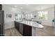 The kitchen features an island, quartz countertops, and a view of the living room creating an open-concept design at 2511 W Queen Creek Rd # 262, Chandler, AZ 85248