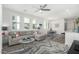 Bright living room featuring a comfortable sofa, decorative rug, and large windows that bring in natural light at 2511 W Queen Creek Rd # 262, Chandler, AZ 85248