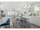 Open-concept living space with large windows, modern decor, and dining area seating, perfect for entertaining and everyday living at 2511 W Queen Creek Rd # 262, Chandler, AZ 85248