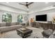 Bright living room featuring a ceiling fan, modern furniture, and large windows at 2511 W Queen Creek Rd # 262, Chandler, AZ 85248