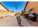 Cozy backyard features gravel, stepping stones, a grill, and is enclosed by block and wood fencing for privacy at 2753 E Kenwood St, Mesa, AZ 85213