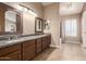 Bathroom featuring double sinks, granite countertop, tile floor, and shower/tub combo at 2753 E Kenwood St, Mesa, AZ 85213