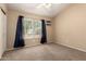 Bedroom with neutral carpet, a ceiling fan and large window at 2753 E Kenwood St, Mesa, AZ 85213