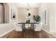 Modern dining room with stylish black table, statement chandelier, and bright window view at 2753 E Kenwood St, Mesa, AZ 85213