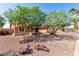 Charming single-story home with xeriscaped front yard and mature trees at 2753 E Kenwood St, Mesa, AZ 85213