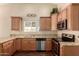 Well-lit kitchen featuring wooden cabinets, granite countertops, and stainless steel appliances at 2753 E Kenwood St, Mesa, AZ 85213