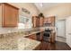 View of the kitchen with granite countertops, stainless steel appliances and wood cabinets at 2753 E Kenwood St, Mesa, AZ 85213