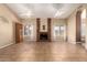 Spacious living room featuring a brick fireplace, tile flooring, and lots of natural light at 2753 E Kenwood St, Mesa, AZ 85213