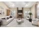 Spacious living room with a brick fireplace, built-in shelving, and a comfortable seating arrangement at 2753 E Kenwood St, Mesa, AZ 85213