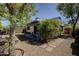 Charming backyard with patio area, stepping stones, shade trees, and privacy fence at 3106 W Mohawk Ln, Phoenix, AZ 85027