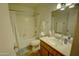 Neutral bathroom features white fixtures, tile floor, and an updated vanity at 3106 W Mohawk Ln, Phoenix, AZ 85027