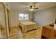 Comfortable bedroom with wood floors, a ceiling fan, and a sliding door closet at 3106 W Mohawk Ln, Phoenix, AZ 85027