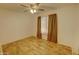 A clean bedroom with wood-look floors, neutral walls, and light from a window at 3106 W Mohawk Ln, Phoenix, AZ 85027