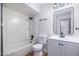 Bright bathroom featuring a tub shower, new vanity, and hardwood floors at 3231 W Willow Ave, Phoenix, AZ 85029