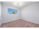 Bedroom featuring modern lighting, carpet floors and a window with natural lighting at 3231 W Willow Ave, Phoenix, AZ 85029