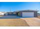 Exterior view of a single story home with a two car garage and desert landscaping at 3231 W Willow Ave, Phoenix, AZ 85029