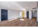 Bright living room featuring hardwood floors, recessed lighting, and three entry doors at 3231 W Willow Ave, Phoenix, AZ 85029