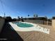 An in-ground pool is nestled in a private backyard with a desert landscape and well-maintained surroundings at 3231 W Willow Ave, Phoenix, AZ 85029
