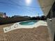 Backyard featuring a clean pool with surrounding sand, enclosed by a brick wall and black fence at 3231 W Willow Ave, Phoenix, AZ 85029