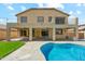 The backyard features a sparkling blue pool and a spacious patio, ideal for entertaining guests at 3370 E Flamingo Ct, Gilbert, AZ 85297