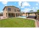 Spacious backyard featuring a large lawn, pool and gazebo with hot tub; a perfect space for outdoor enjoyment at 3370 E Flamingo Ct, Gilbert, AZ 85297