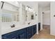 Bathroom with dual sinks, large mirrors and white cabinetry at 3370 E Flamingo Ct, Gilbert, AZ 85297