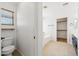 Bright bathroom featuring a soaking tub and walk-in closet, offering both relaxation and ample storage at 3370 E Flamingo Ct, Gilbert, AZ 85297