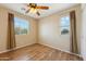 Bright bedroom features hardwood floors, ceiling fan, and windows that provide plenty of natural light at 3370 E Flamingo Ct, Gilbert, AZ 85297