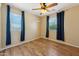 Bedroom featuring laminate flooring, natural lighting from the window, and contemporary ceiling fan at 3370 E Flamingo Ct, Gilbert, AZ 85297