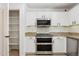 Modern kitchen with stainless steel double oven, granite countertops and white cabinetry at 3370 E Flamingo Ct, Gilbert, AZ 85297