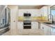 Bright kitchen showcasing stainless steel appliances, granite countertops, and sleek white cabinetry at 3370 E Flamingo Ct, Gilbert, AZ 85297