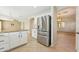 Spacious kitchen area with granite counters, stainless steel refrigerator, and seamless access to living areas at 3370 E Flamingo Ct, Gilbert, AZ 85297