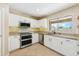 Well-appointed kitchen featuring stainless steel appliances, ample cabinet space, and a convenient window view at 3370 E Flamingo Ct, Gilbert, AZ 85297