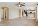Expansive living room featuring tile floors, a ceiling fan, and seamless flow into an adjacent modern kitchen at 3370 E Flamingo Ct, Gilbert, AZ 85297