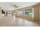 Open-concept living room with tile floors, backyard access, and modern kitchen at 3370 E Flamingo Ct, Gilbert, AZ 85297